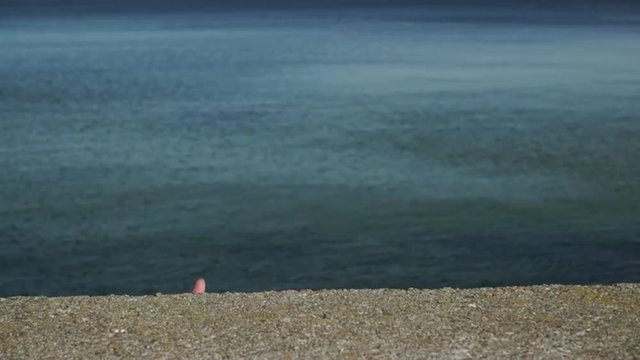 Male hand making thumb up gesture against sea water 4K