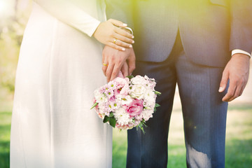 Bride and groom holding wedding bouquet