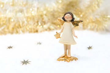 Christmas card in gold colour: ceramic girl-angel with gold stars.