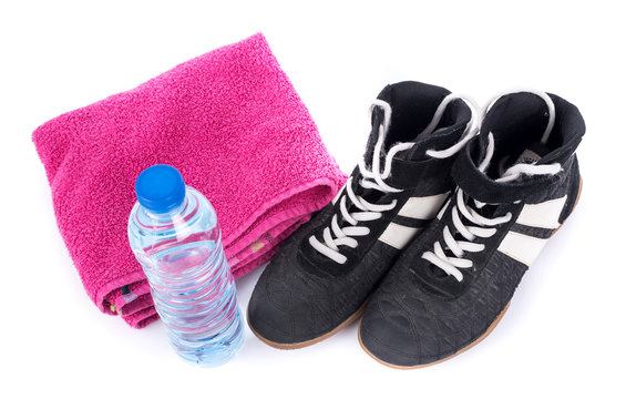 Sport shoes with terry towel and bottle of water