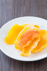 Fototapeta na wymiar Piece of Dehydrated mango on white ceramic dish