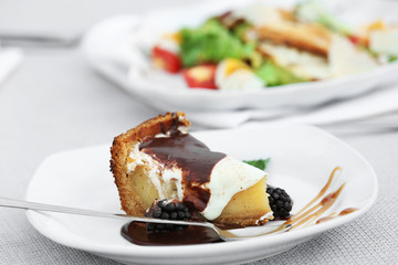 Delicious cake under chocolate glaze with blackberry, close up