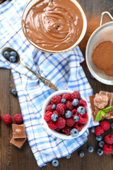 Beautiful composition with chocolate cream and ripe berries