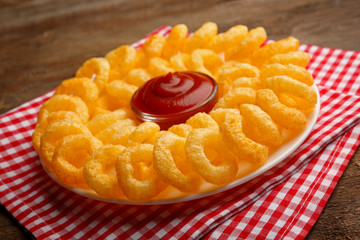 Chips rings with sauce on plate closeup