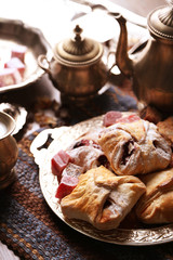 Antique tea-set with Turkish delight and baking on table close-up