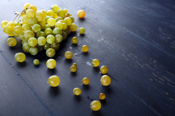 Juicy green grapes, on wooden background