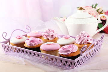 Tasty cupcakes on tray, close-up