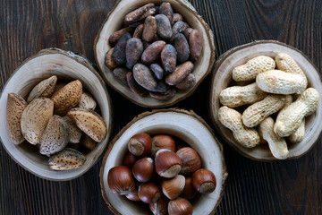 Assortment of tasty nuts on wooden background