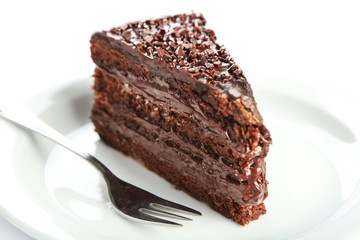 Fototapeta na wymiar Chocolate cake with chocolate cream on plate isolated on white