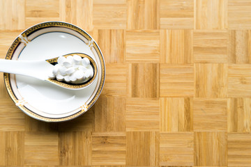 White pills on Asian spoon