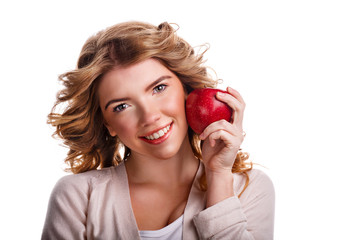 Girl with curly hair holding a red apple and smiling.