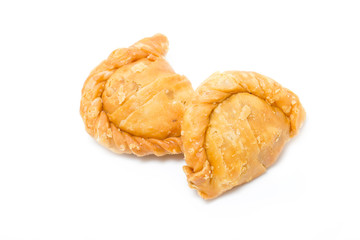 Two curry puffs isolated on white.