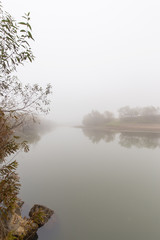 Naklejka na ściany i meble Fog and mist on a wild river, on an autumn day