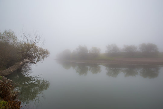 Fog and mist on a wild river, on an autumn day
