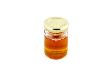 Honey in a glass bottles on white background