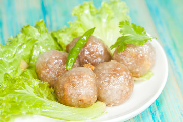 Tapioca Balls with Pork Filling and Paprika on Lettuce