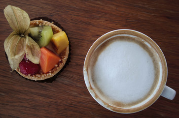 Cup of hot coffee and fruit tart