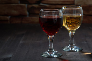 two glasses of wine on the background of a brick wall