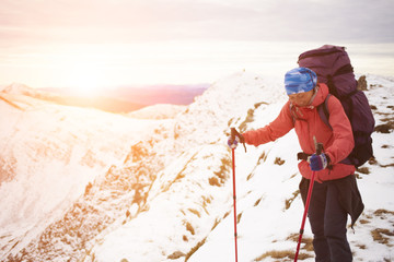 Girl with backpack is traveling in the mountains.