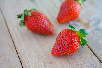 Fresh red strawberries on wooden table