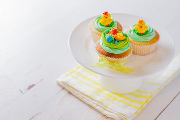 Easter cupcakes on white wood background