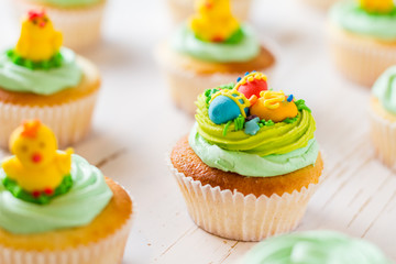 Easter cupcakes on white wood background