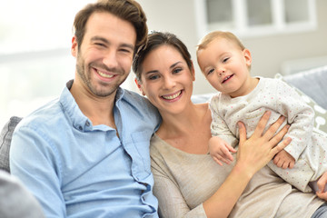 Fototapeta premium Portrait of happy young family of three