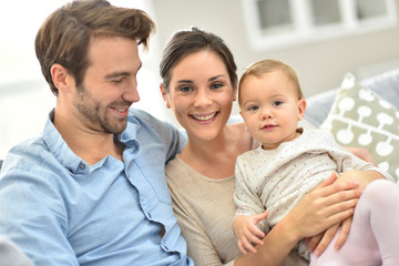 Obraz premium Portrait of happy young family of three