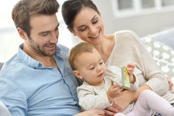 Fototapeta premium Portrait of happy young family of three