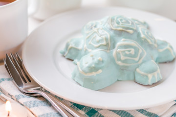 Turtle shapped cake on white plate