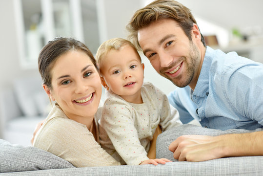 Portrait of happy young couple with baby girl