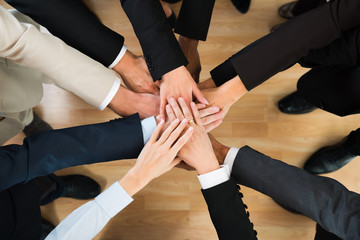 Business Team Stacking Hands On Table