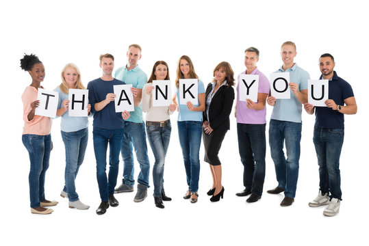 Creative Business People Holding Thank You Sign