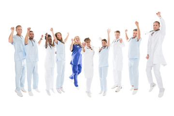 Obraz premium Multiethnic Medical Team Standing With Arms Raised