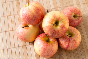 Ripe juicy apples on bamboo mat
