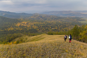 Fototapeta na wymiar Two hikers traveling along the ridge