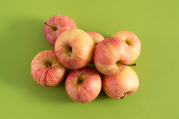 Ripe apples on a green background