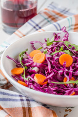 Red cabbage salad with carrot and arugula