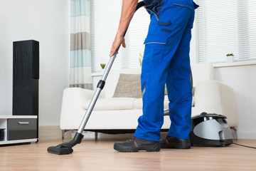 Janitor Cleaning Floor With Vacuum Cleaner