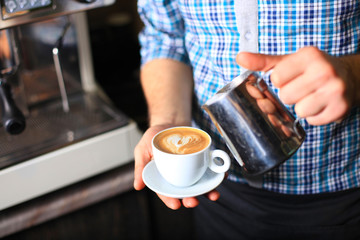 Fototapeta na wymiar how to make latte art by barista focus in milk and coffee