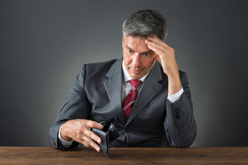 Shocked Businessman With Empty Wallet