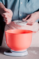 Man sifting flour for pizza dough