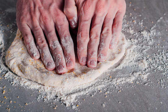 Man making dough for pizza