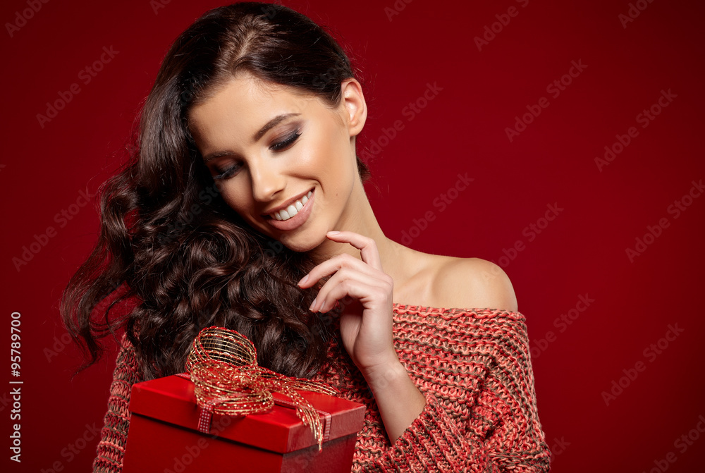 Wall mural Beautiful woman portrait hold gift in christmas color style . Sm