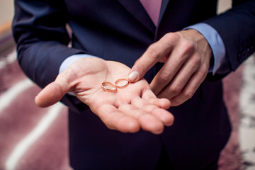 Wedding rings in groom's hand