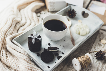 Cozy vintage toned winter holidays Christmas Composition with Gifts Boxes and Balls, Pine Cones Wooden Background. Styled photography for blog posts.