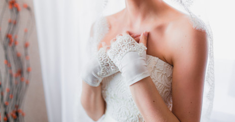 Hands of the bride with gloves