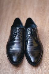 fashionable mens black shoes on a floor