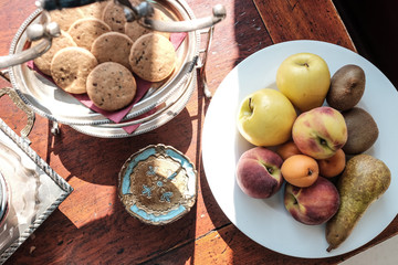 Autumn fruits and cookies on table
