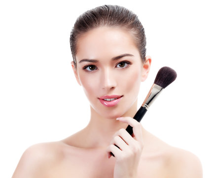 Pretty woman with makeup brush